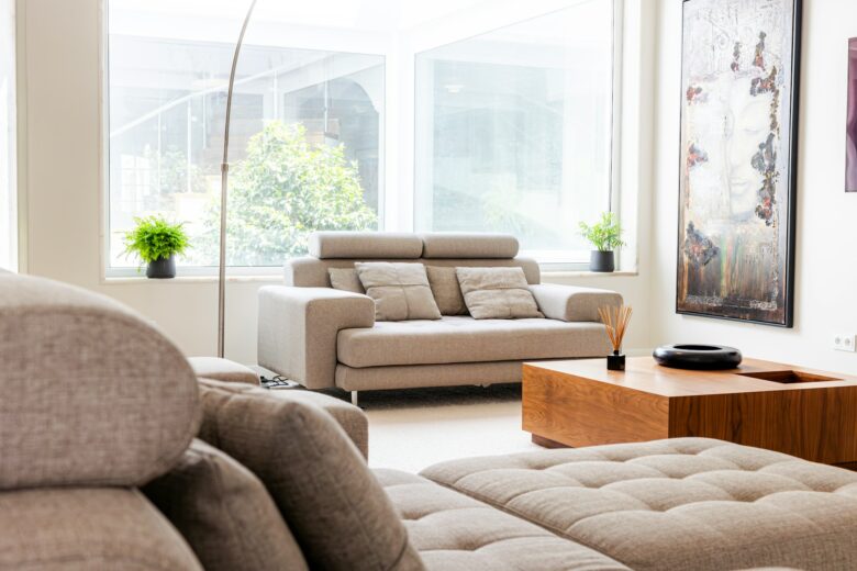 Modern small living room styled with light colors and minimal furniture to look bigger without renovation